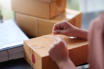 Close-up of an online business owner woman check customer lists to properly pack and ship to customer.