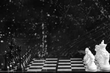 Black and white chess pieces on chessboard.