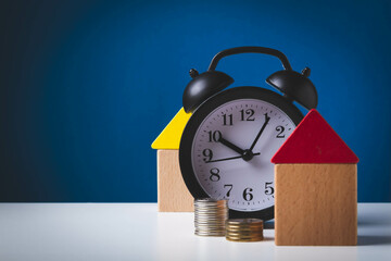 Time to buy a home. Money, house and watch. Money to buy a house.