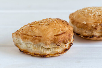 Israeli Savory Cheese Pastry Bourekas on white wooden background.