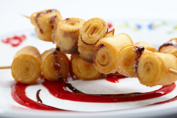 fried sweet rolls with berry sauce