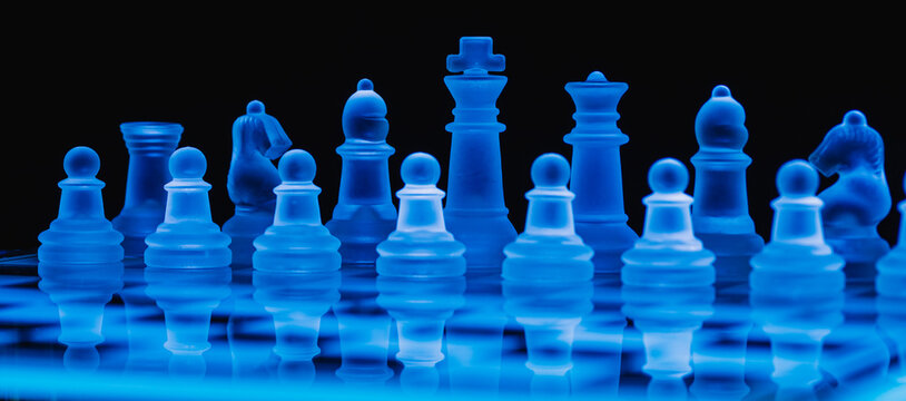 Glass chess on chess board. Close up with the black background