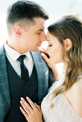 Groom touches bride forehead with his nose. Portrait