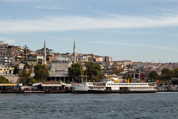 Fototapeta na wymiar View of traditional ferry boat at Uskudar pier on Asian side of Istanbul. It is a sunny summer day. Beautiful scene.