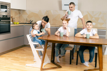 Happy family having breakfast together in kitchen