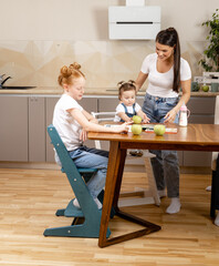 learning at home, children in the kitchen studying while the whole family is sitting at the table with them