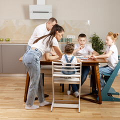 young family with three children in the kitchen