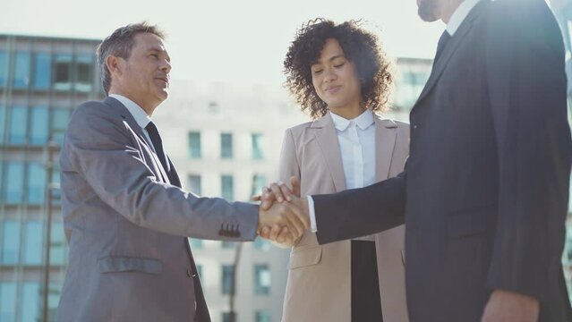 Cinematic footage of business colleagues talking about sales strategy during the break, celebrating the new deal. Concept about businesspeople and finance