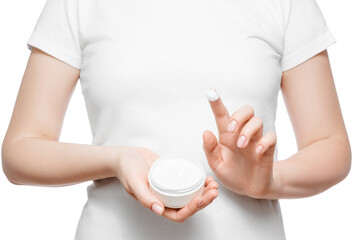 Close up shot of a woman in white t-shirt holding a jar of hand cream, isolated on white. Short natural nails.
