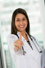 Hispanic female doctor holding one finger up