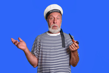 no answer - image. An old sailor with a confused look. Smoking pipe, marine uniform. on a blue...