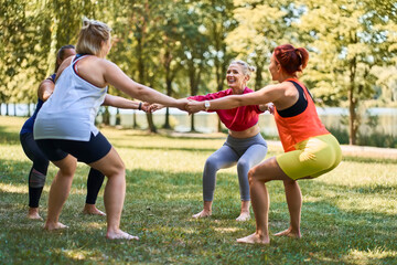 Group of women exercising together during outdoor fitness class in park