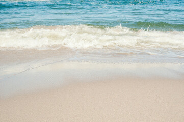 Soft sea waves on a sandy beach. Vacation concept