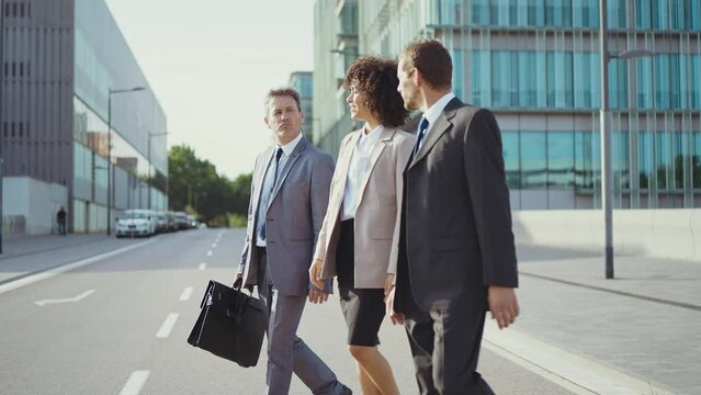 Cinematic footage of business colleagues talking about sales strategy during the break, walking out the office. Concept about businesspeople and finance