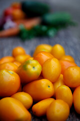 Fresh organic yellow tomatoes. Eco friendly non-gmo yellow tomatoes on the table. The concept of health, non-gmo products, clean ecological food.