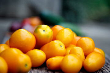 Fresh organic yellow tomatoes. Eco friendly non-gmo yellow tomatoes on the table. The concept of health, non-gmo products, clean ecological food.