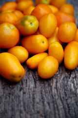 Fresh organic yellow tomatoes. Eco friendly non-gmo yellow tomatoes on the table. The concept of health, non-gmo products, clean ecological food.