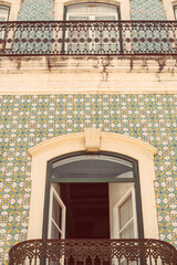 Detail of a Portugese house. Pastel colours.Tiles and balcony. High quality photo