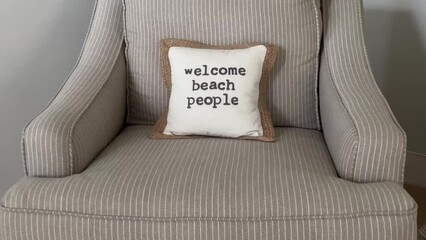 A pillow that says welcome beach people in a condo in Florida.