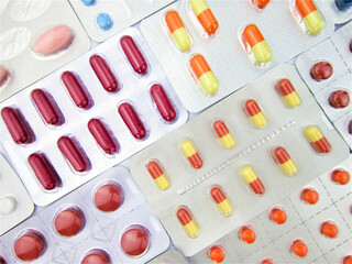    Colorful tablets and capsule pills in blister pack. Pharmaceutical industry. Drug and herbal interactions. Pharmacy pharmacy. Pharmacy concept. Health abstract. Pharmaceutical production