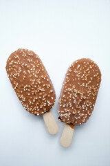 Ice cream in chocolate glaze on a light background. Natural ice cream close-up. Summer sweet delicious cold dessert. traditional dairy product
