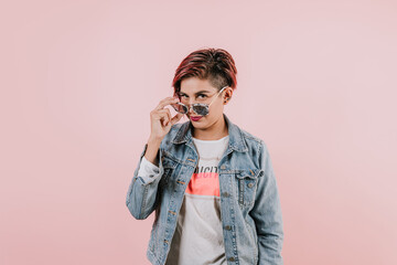 latin girl young woman with sunglasses and casual clothes on pink coral studio background in Mexico Latin America