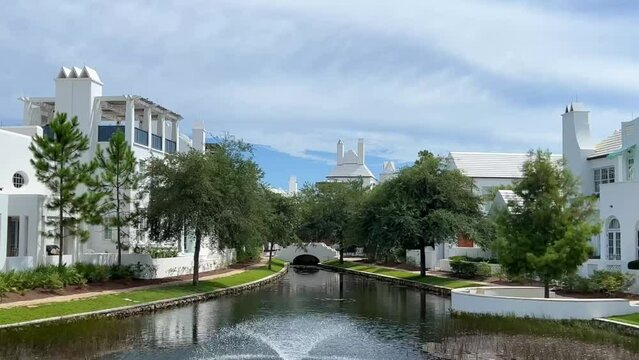 A walking path with water feature and homes in Alys Beach, Florida.