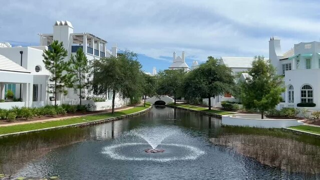 A walking path with water feature and homes in Alys Beach, Florida.