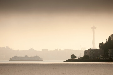 Ferry Boat Entering Elliott Bay On a Foggy Morning With The Space Needle Silhouetted In The...