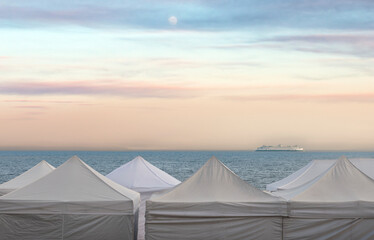 Tent Tops and Ferry Boat. Ferry boat in Elliott Bay with art fair display tents in the foreground...