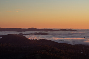sunset in the mountains with a sea of fog