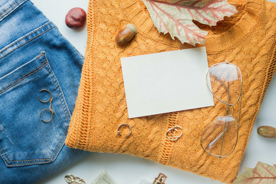 card mockup with yellow sweater and blue jeans, golden details, tea with lemon and fall leaves