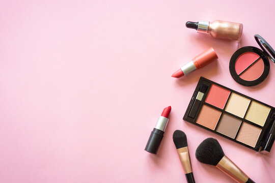 Makeup professional cosmetics on pink background. Flat lay image with copy space.