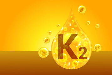 Vitamin K2. Golden drops with oxygen bubbles. Health concept - 520679553