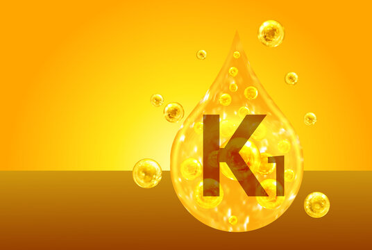 Vitamin K1. Golden drops with oxygen bubbles. Health concept