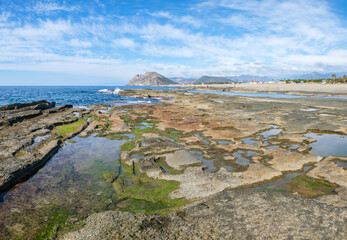 Fototapeta na wymiar Antalya, Turkey, Natural rock formations at Koru beach with people by the mediterranean sea, Gazipasa.