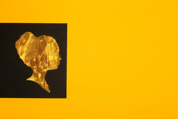 yellow female water head on black background surrounded by yellow copy space, creative art modern design
