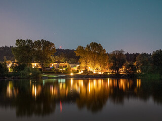 Fototapeta na wymiar Evening picture of houses next to small lake in Koseze (Lubiana, Slovenia)