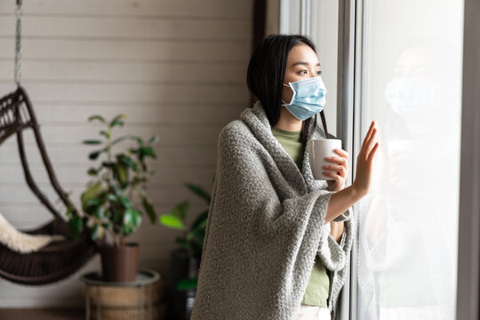 Asian Girl In Medical Face Mask, Yearning Go Outside, Being Sick With Covid 19 And Staying On Self Quarantine In Her House