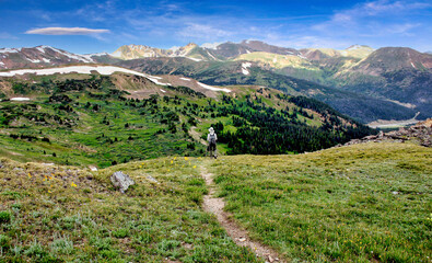 Fototapeta na wymiar A hiker at 12,000 feet on the Continental Divide near Colorado's Loveland Pass.
