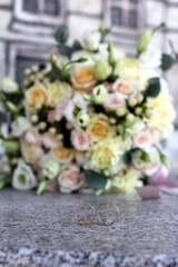 Obraz na płótnie Canvas wedding rings on the background bouquet
