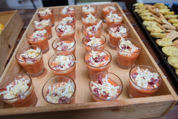 Rustic tray wooden box full of gazpacho shots