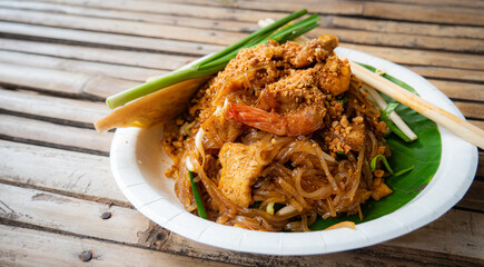 Pad Thai, fresh shrimp, popular food, famous in Thailand. It is a type of noodles, stir-fried dry, add meat or seafood, squid, sprinkled with ground peanuts, seasoned with sugar, fish sauce and chili 