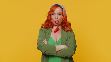 Funny joyful sincere redhead woman 20s in jacket making playful silly facial expressions and...
