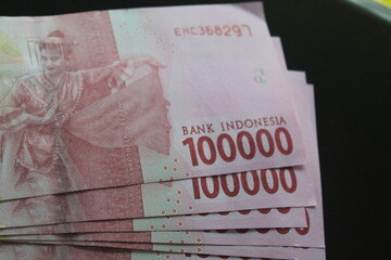 rear view of several hundred thousand rupiah banknotes