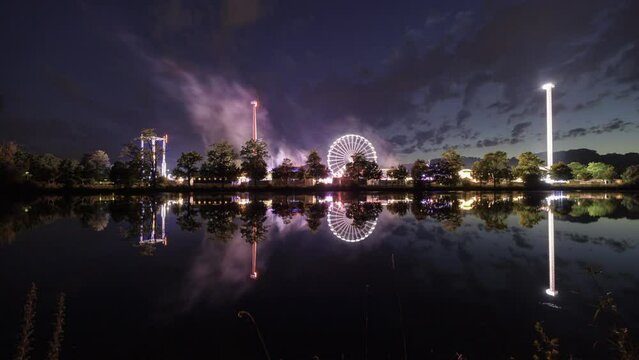 Fair at dusk with clouds reflecting in river Danube time lapse
