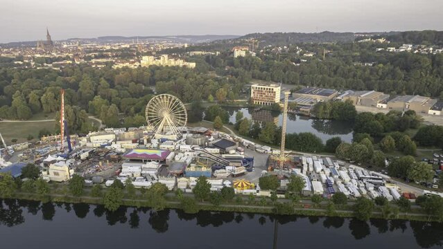 Aerial time lapse shot of a closed fair in the morning in a park next to river Danube.