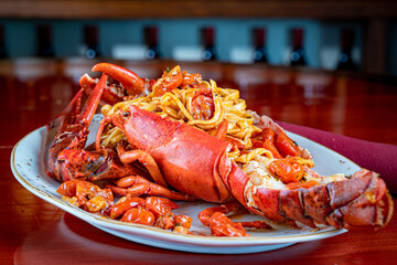 Whole Lobster stuffed with Pasta and topped with a Butter Tomato Sauce.