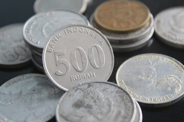 Indonesian rupiah coins with a nominal value of five hundred rupiahs among other coins