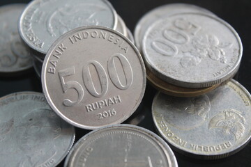 Indonesian rupiah coins with a nominal value of five hundred rupiahs among other coins